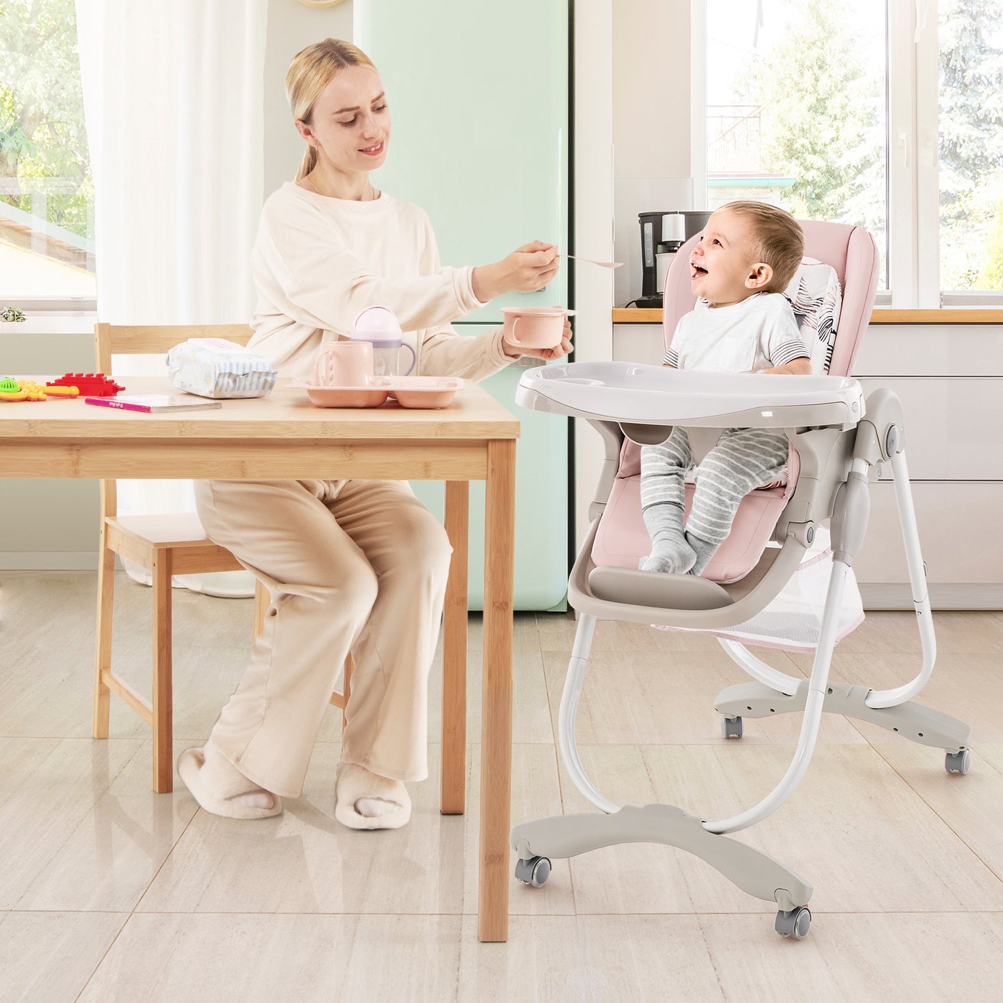 Multifunctional Folding Baby High Chair with Rolling Wheels Pink mother feeding baby