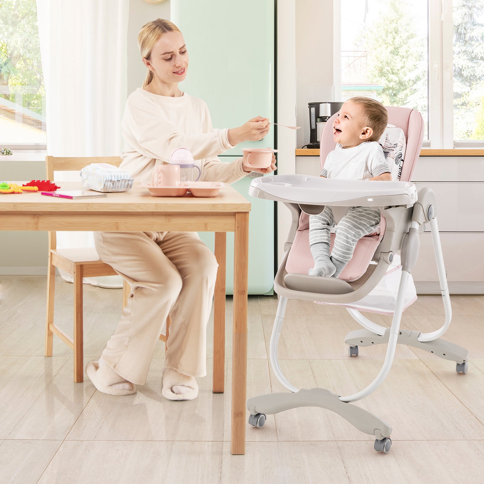 Multifunctional Folding Baby High Chair with Rolling Wheels Pink mother feeding baby