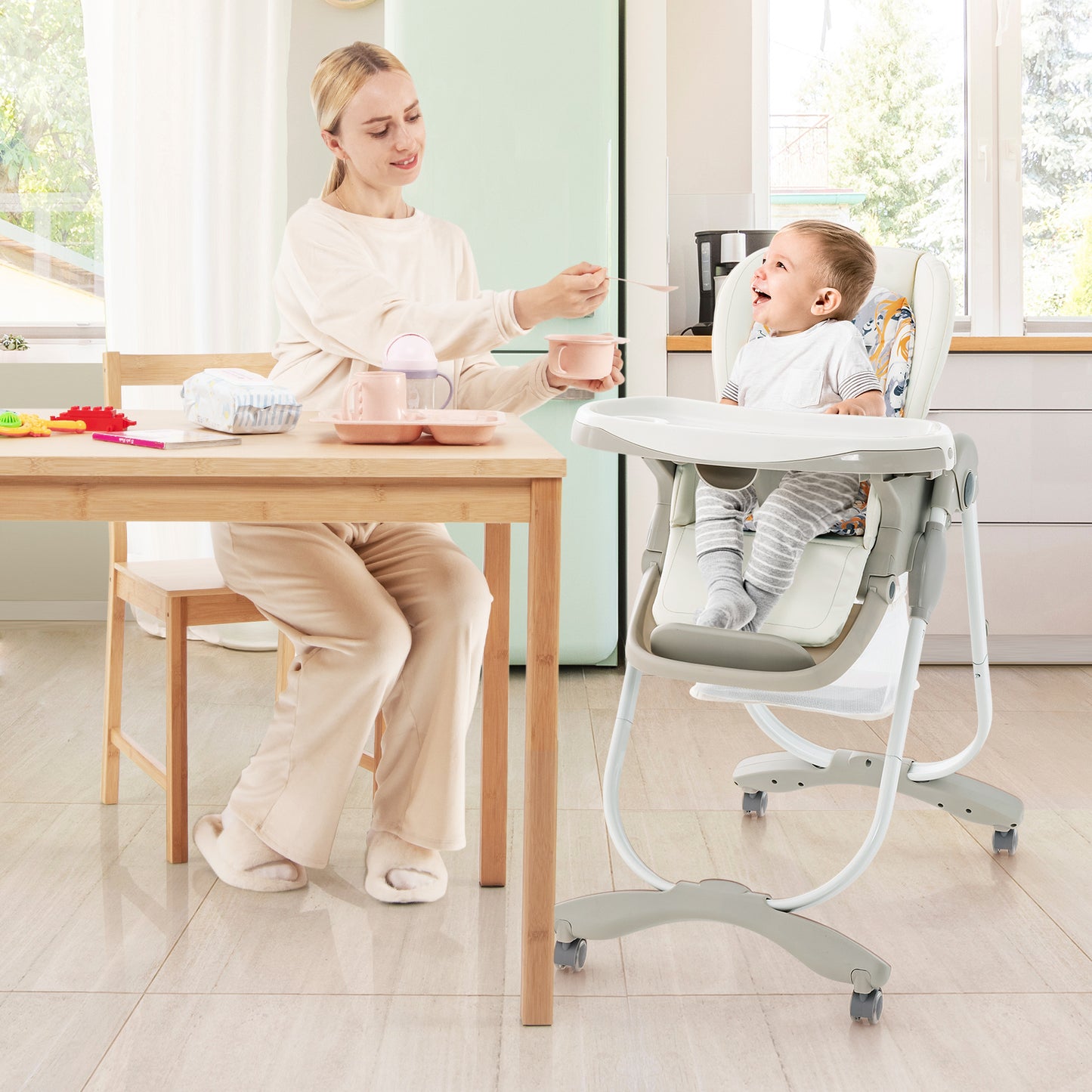 Multifunctional Folding Baby High Chair with Rolling Wheels White Mum feeding baby, 